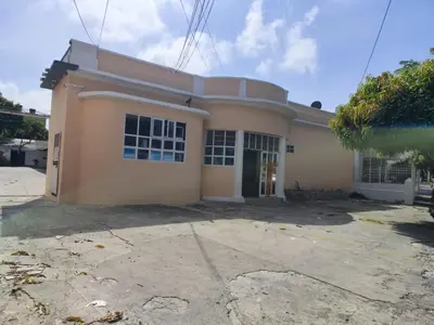 a large house with a driveway in front of it at Hotel El Tesoro in Barranquilla