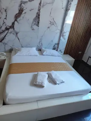 two towels on a bed in a room at Hotel El Tesoro in Barranquilla