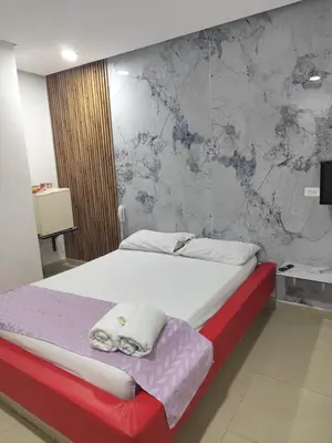 a bedroom with a bed with towels on it at Hotel El Tesoro in Barranquilla