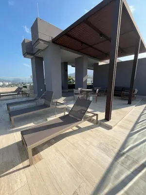 a patio with chairs and tables on a building at Terraza del Mar in Santa Marta