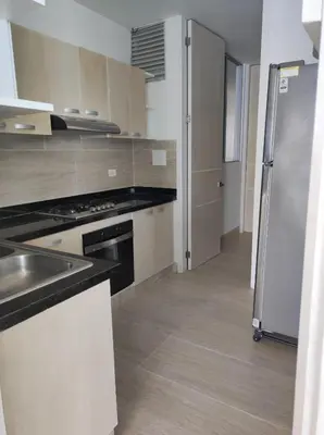 a kitchen with a stainless steel refrigerator and cabinets at Apto Coveñas in Coveñas