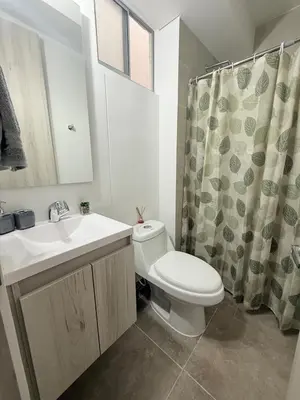 a bathroom with a toilet and a sink and a shower curtain at Apartamento Hermoso en Manzanillo del Mar Cartagena in Cartagena de Indias