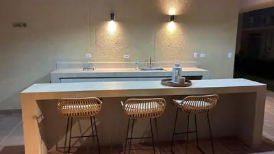 a kitchen with a sink and two bar stools at Apartamento Hermoso en Manzanillo del Mar Cartagena in Cartagena de Indias