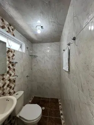 a bathroom with a white toilet and a sink at Rojas House in Barranquilla