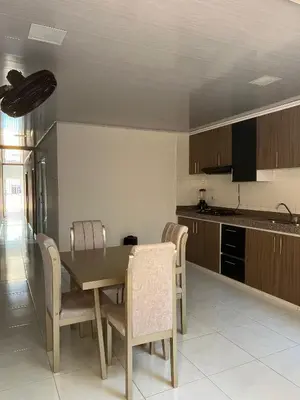 a kitchen with a dining room table and chairs at Rojas House in Barranquilla