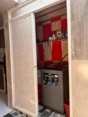 a garage door in a kitchen with a washing machine at Rojas House in Barranquilla