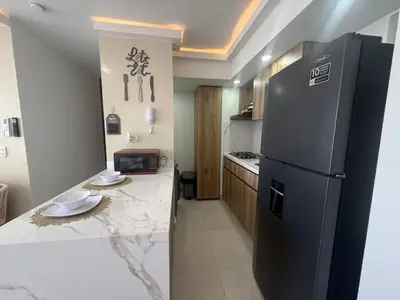 a kitchen with a black refrigerator and a counter at Apartamento con cercania al Mar y centro historico in Cartagena de Indias