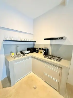 a small kitchen with a sink and a stove at Private loft near the airport with fast WiFi in Cartagena de Indias