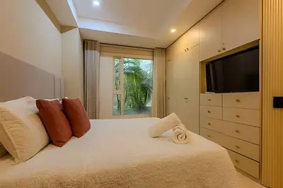 a bedroom with a large bed with a flat screen tv at Colonial Elegance in Historic Center /Pool in Cartagena de Indias