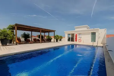 a swimming pool in front of a house at Colonial Elegance in Historic Center /Pool in Cartagena de Indias
