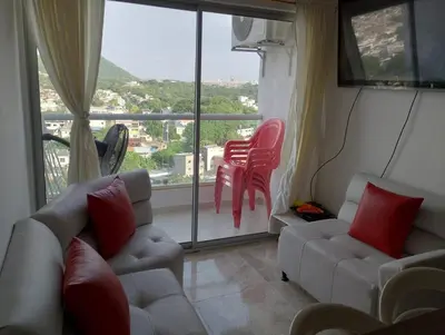 a living room with two couches and a large window at 3 Bedroom Apartment in Cartagena 5 Min to The Beach and The Walled City in Cartagena de Indias