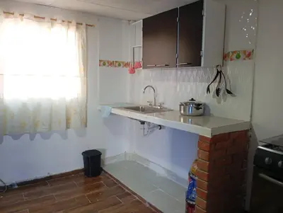 a small kitchen with a sink and a window at Tefi beach in Puerto Colombia