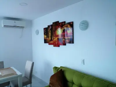 a living room with a green couch and a blue light at Cartagena Sotavento Laguito in Cartagena de Indias