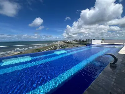 a swimming pool on top of a building next to the ocean at OceanDrive509 in Cartagena de Indias