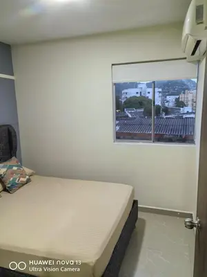 a small bedroom with a bed and a window at Lujoso Apartamento en Cartagena in Cartagena de Indias