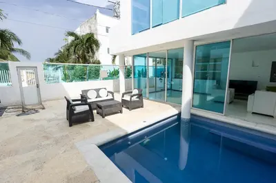 a house with a swimming pool next to a building at Luxury House Cartagena Private pool in Cartagena de Indias