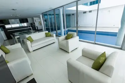 a living room with white couches and a pool at Luxury House Cartagena Private pool in Cartagena de Indias