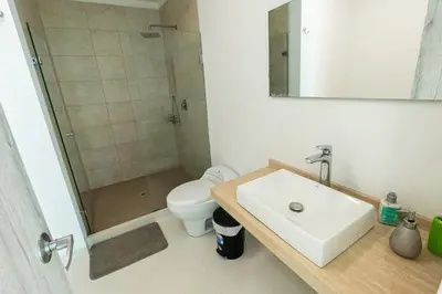 a bathroom with a toilet and a sink and a shower at Luxury House Cartagena Private pool in Cartagena de Indias