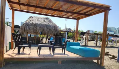 a pavilion with chairs and a couch on a beach at Luxury House Cartagena Private pool in Cartagena de Indias
