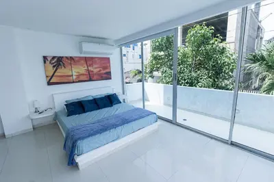 a bedroom with a bed and a large window at Luxury House Cartagena Private pool in Cartagena de Indias