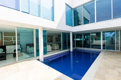 a house with a swimming pool in the middle of it at Luxury House Cartagena Private pool in Cartagena de Indias