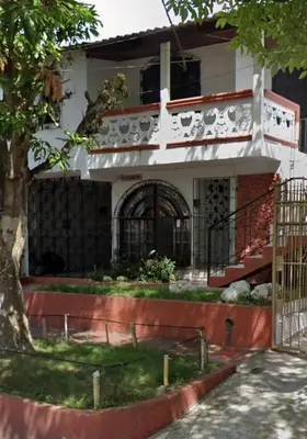 a house with a gate in front of it at Carnival Hostel BAQ in Barranquilla