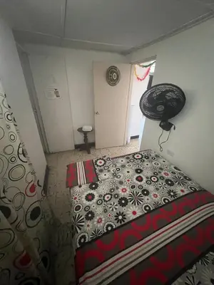 a bedroom with a bed in a room at Carnival Hostel BAQ in Barranquilla