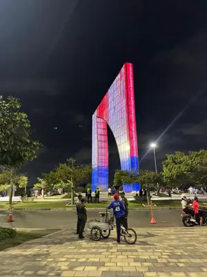 a building is lit up red and blue at night at CARIBE STAY - Apto in Barranquilla
