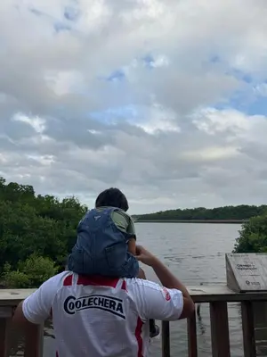 a man with a backpack on his back looking at the water at CARIBE STAY - Apto in Barranquilla