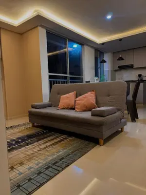 a couch with two pillows in a living room at CARIBE STAY - Apto in Barranquilla