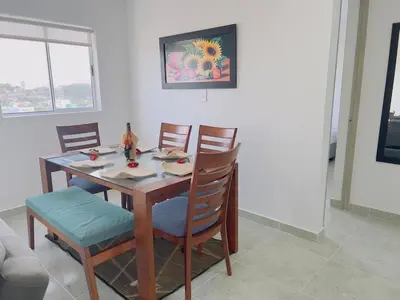 a dining room table and chairs in a room at Beach Lotus 1203 in Cartagena de Indias