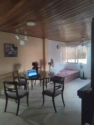 a living room with a table and chairs and a bed at Oasis del Manglar in Cartagena de Indias