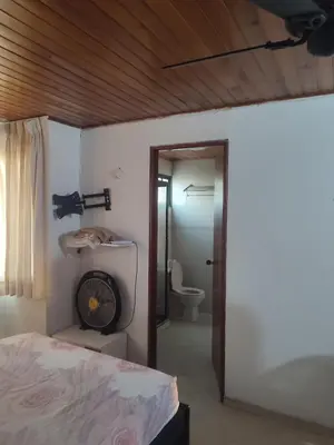a bedroom with a bed and a bathroom with a toilet at Oasis del Manglar in Cartagena de Indias