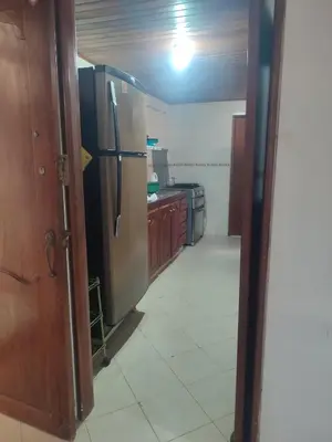 a kitchen with a stainless steel refrigerator in a room at Oasis del Manglar in Cartagena de Indias