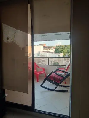 a room with a balcony with two chairs and a window at Oasis del Manglar in Cartagena de Indias