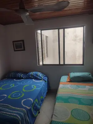 a bedroom with two beds and a window at Oasis del Manglar in Cartagena de Indias