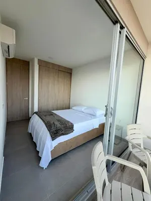 a bedroom with a bed and some chairs in it at BRISA MARINA, Santa Marina Condominio in Santa Marta
