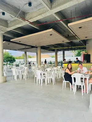 a group of people sitting at tables and chairs at BRISA MARINA, Santa Marina Condominio in Santa Marta