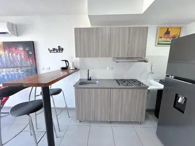a small kitchen with a sink and a stove at Acogedor Apto Cerca A La Playa WiFi Piscina AC in Cartagena de Indias