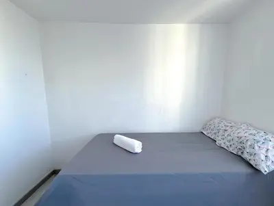 a bed with a roll of paper on it in a room at Acogedor Apto Cerca A La Playa WiFi Piscina AC in Cartagena de Indias
