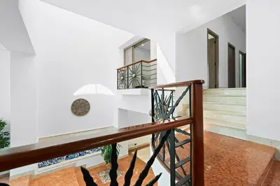 a staircase in a house with white walls at 10BR Mansion Beachfront w Pool and Disco in Cartagena de Indias