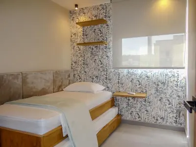 a small bedroom with a bed and a window at Apto chic con AC 3 hab 2 baños cerca al Mar in Cartagena de Indias