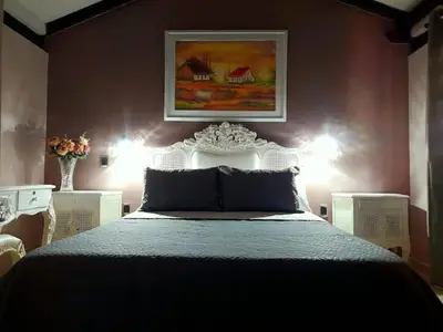 a bedroom with a large bed with two lights at Habitación Luminosa Manga in Cartagena de Indias