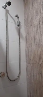 a shower with a shower head and a shower curtain at Habitación Luminosa Manga in Cartagena de Indias