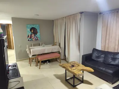 a living room with a couch and a table at Cómoda habitación cerca de la via 40 Carnaval Barranquilla in Barranquilla
