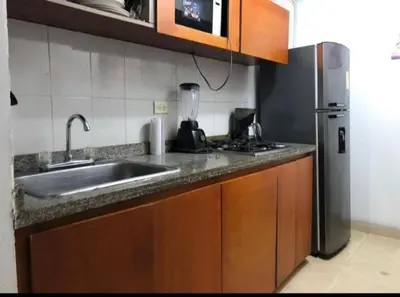 a kitchen with a sink and a refrigerator at Cómoda habitación cerca de la via 40 Carnaval Barranquilla in Barranquilla