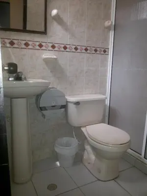 a bathroom with a toilet and a sink at hotel hispanoamericano in Barranquilla