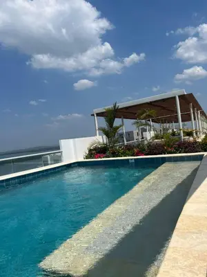 a swimming pool with the ocean in the background at Exclusivo apartamento para descanso en Cartagena in Cartagena de Indias