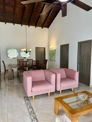 a living room with two pink couches and a table at Cozy Apartment Near Airport, Beaches & Old City in Cartagena de Indias
