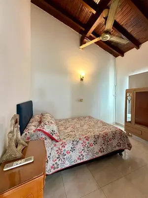 a bedroom with a bed and a dresser in it at Cozy Apartment Near Airport, Beaches & Old City in Cartagena de Indias